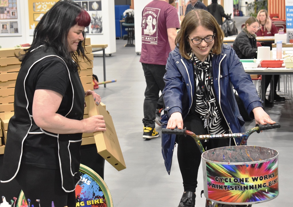 Kirsty Winterton from Cycolne Works helps a staff member from the EEG create art work through peddle power