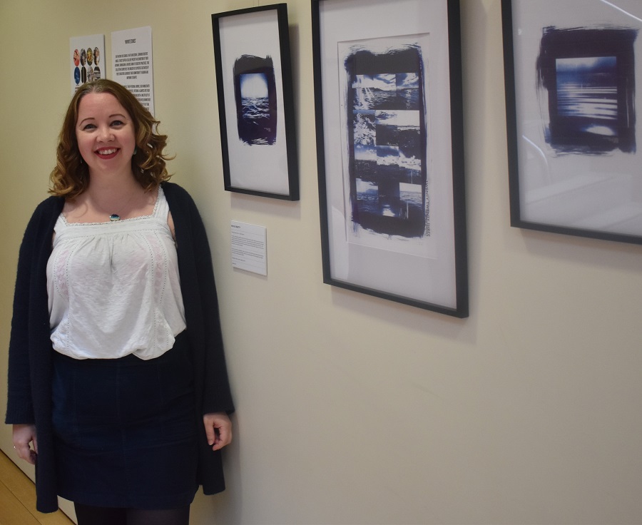 Nicole Beatty by her artwork at The Apex that explore her love of outdoor swimming