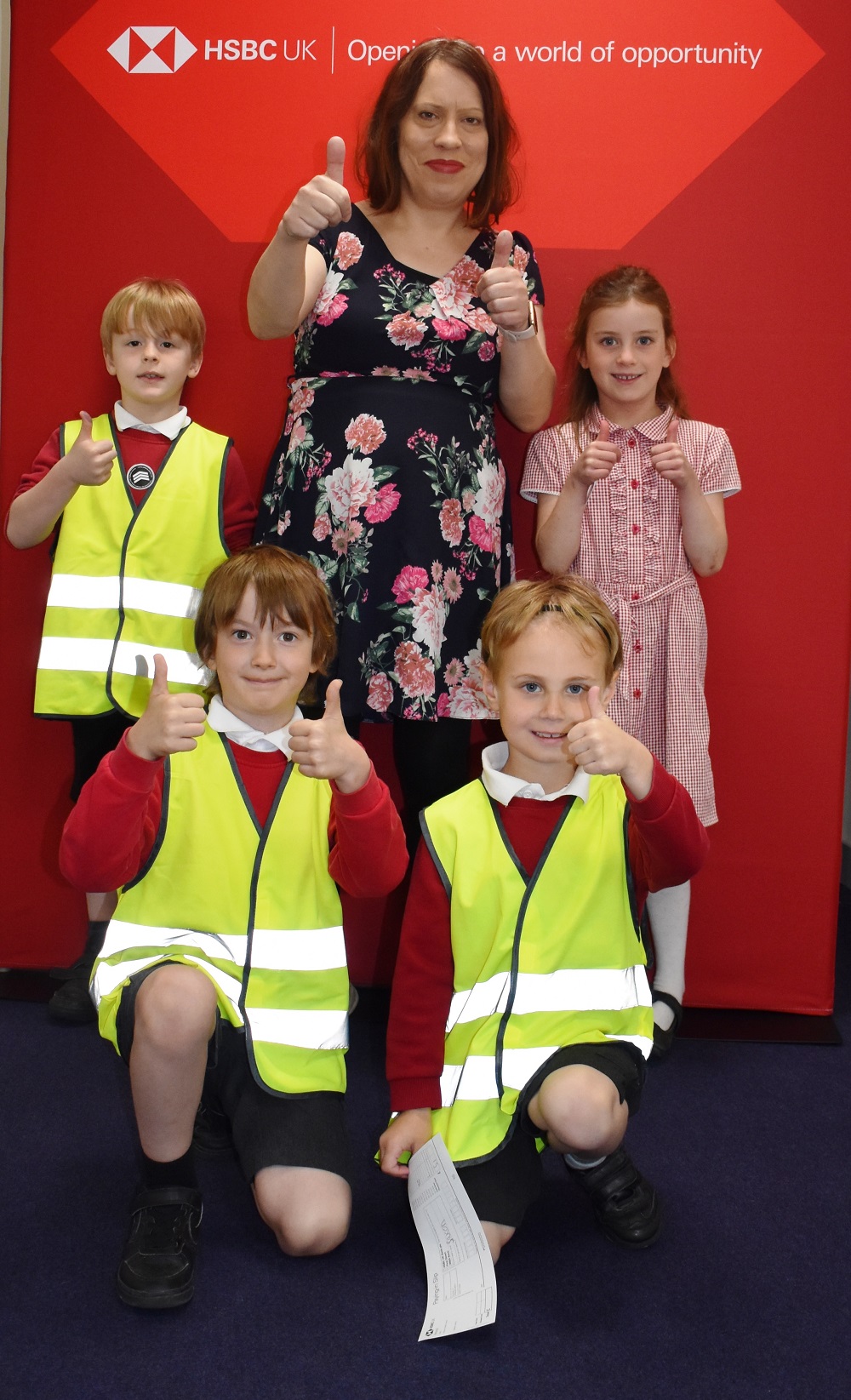 Miss East and children learning about banking with HSBC