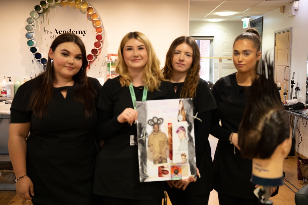 Hairdressing students with their work