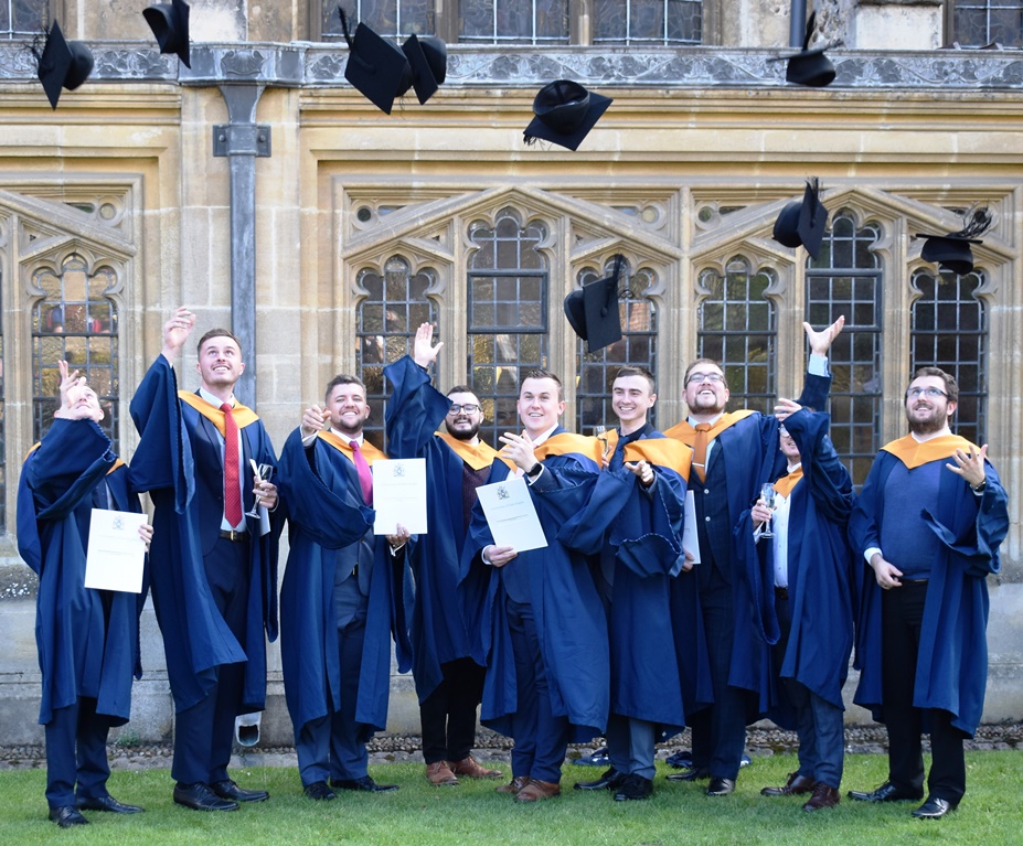 Graduates throwing their hats into the air at St Edmundsbury Cathedral at Graduation 2022