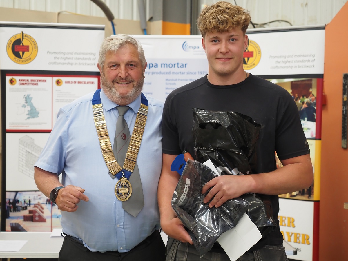 Gentleman presenting award to bricklaying competition winner - Zac Hillman won the East South Midlands regional heat, and then went on to receive a pretigious certificate of merit medal in the final.