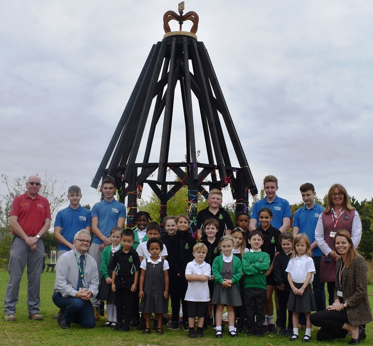 Students of West Suffolk College and pupils of Abbots Green Primary School with giant wooden jubilee crown.