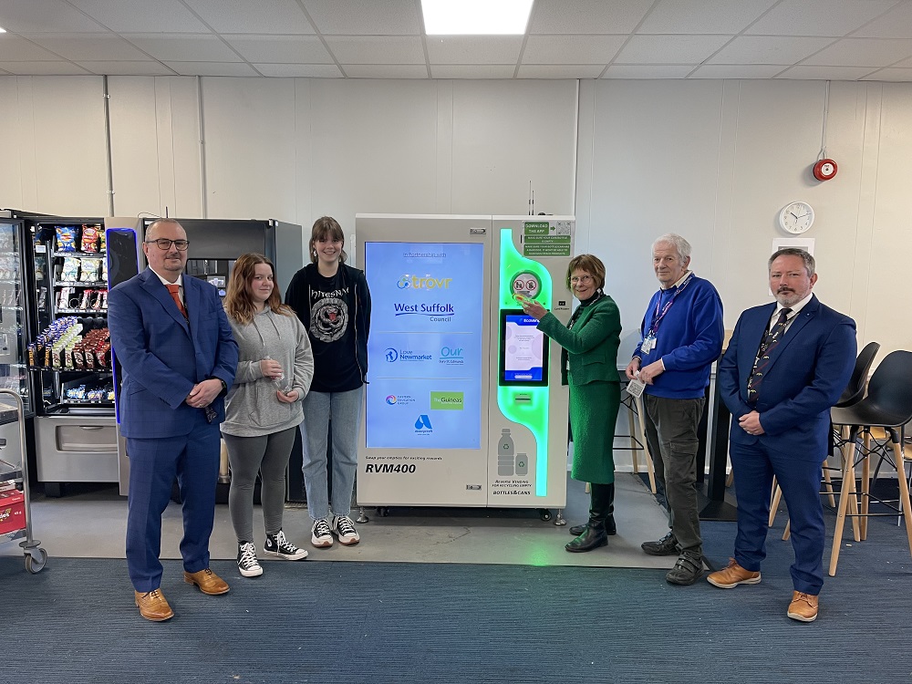 Team with bottle recycling machine at West Suffolk College
