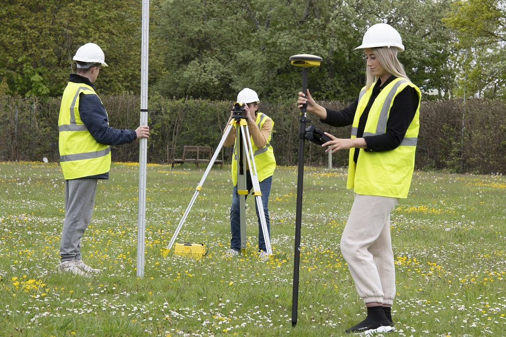 Students using specialist equipment to do field surveys