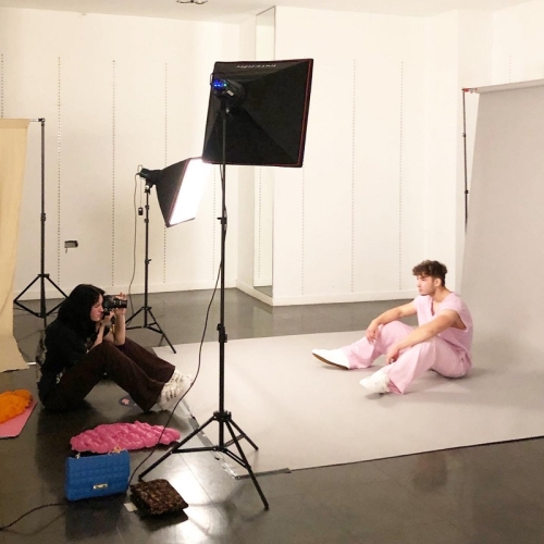 photographer taking an image of a person in light pink clothing