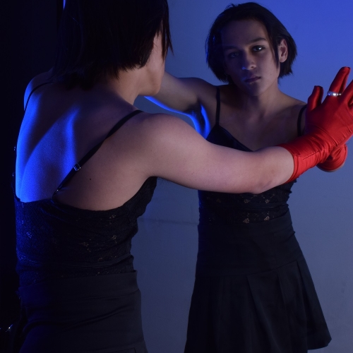 person posing into a mirror and looking at the camera from the reflection
