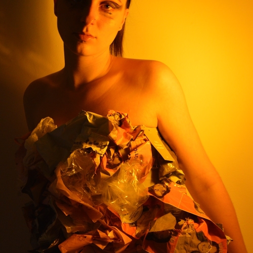 Person posing with yellow attire and a yellow background