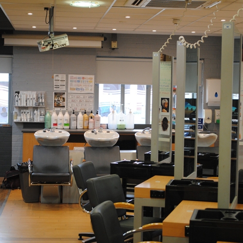 Mirrored hairdressing stations and hair wash basins