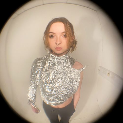Photo of a person wearing a silvery outfit with a fisheye effect on the camera