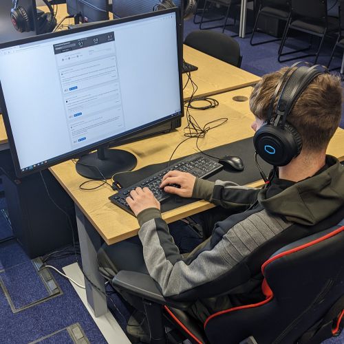 photo of someone sitting at a desk using a PC