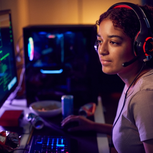 Photo of a person sitting at a desk using a PC