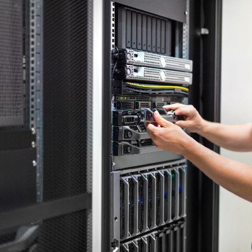 Photo of a person installing tech into a server rack
