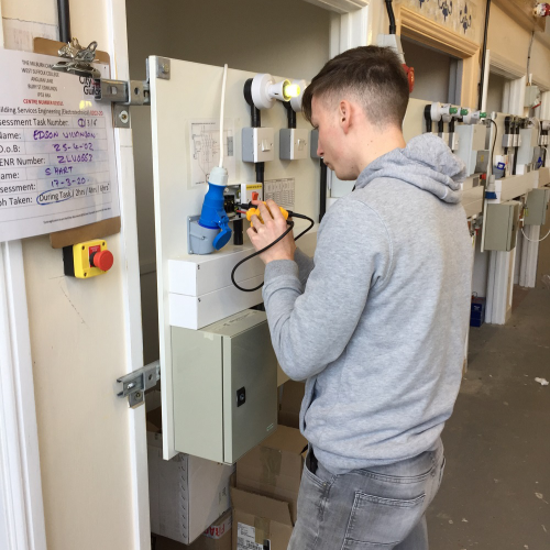 Photo of student testing a switch during an assessment
